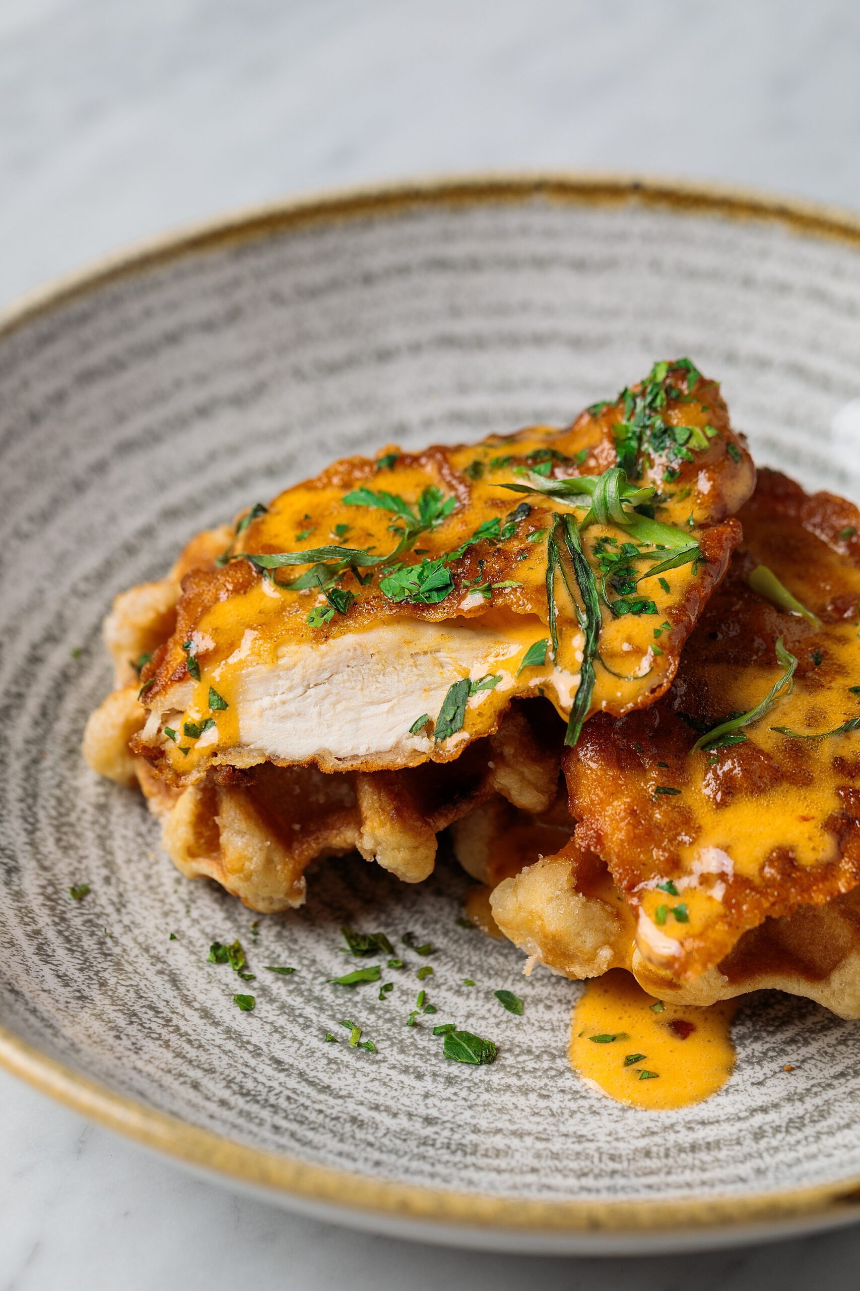 chicken and waffles in a ceramic custom bowl