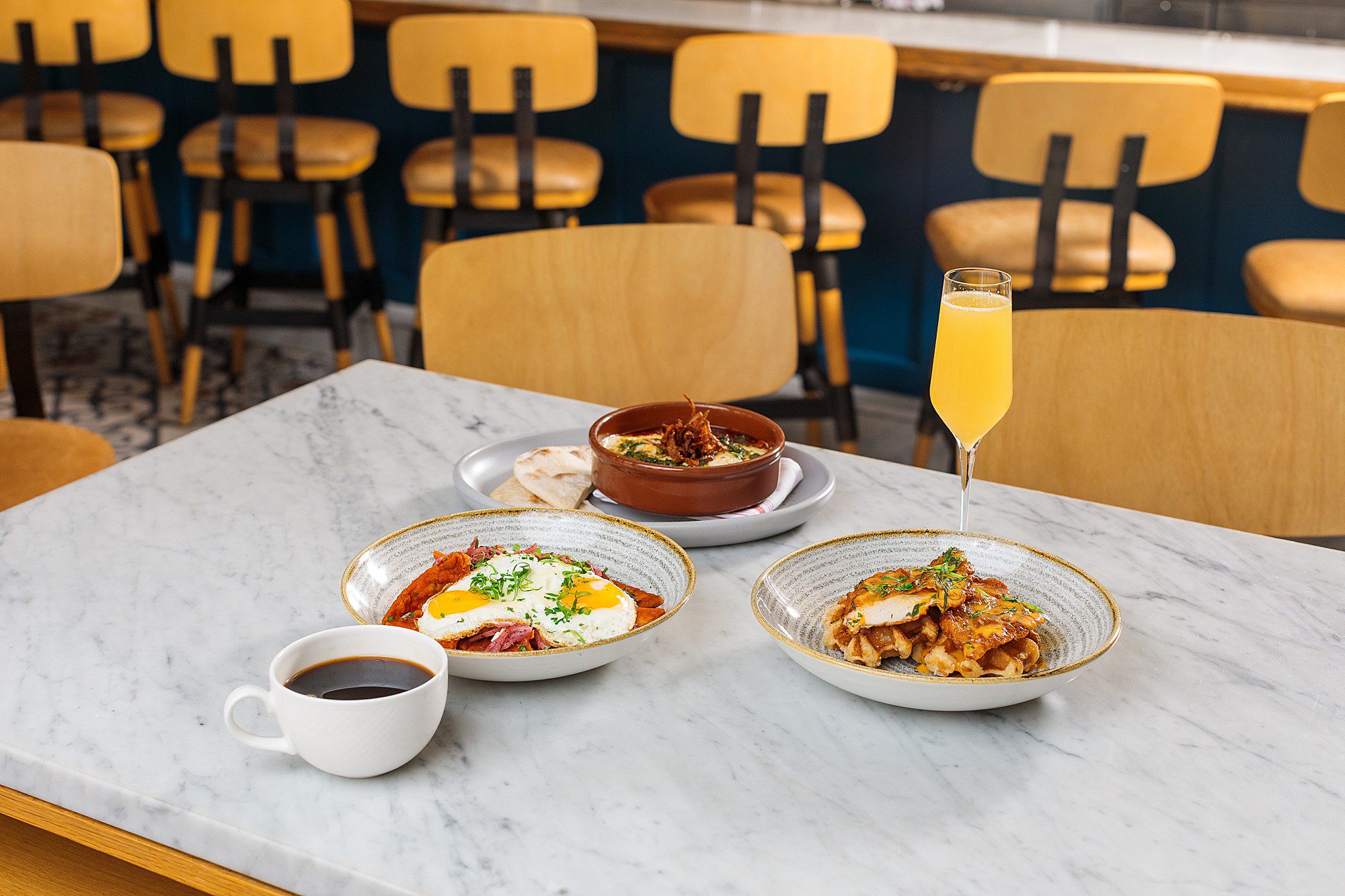 brunch dishes on a marble tabletop at a pretty boutique hotel