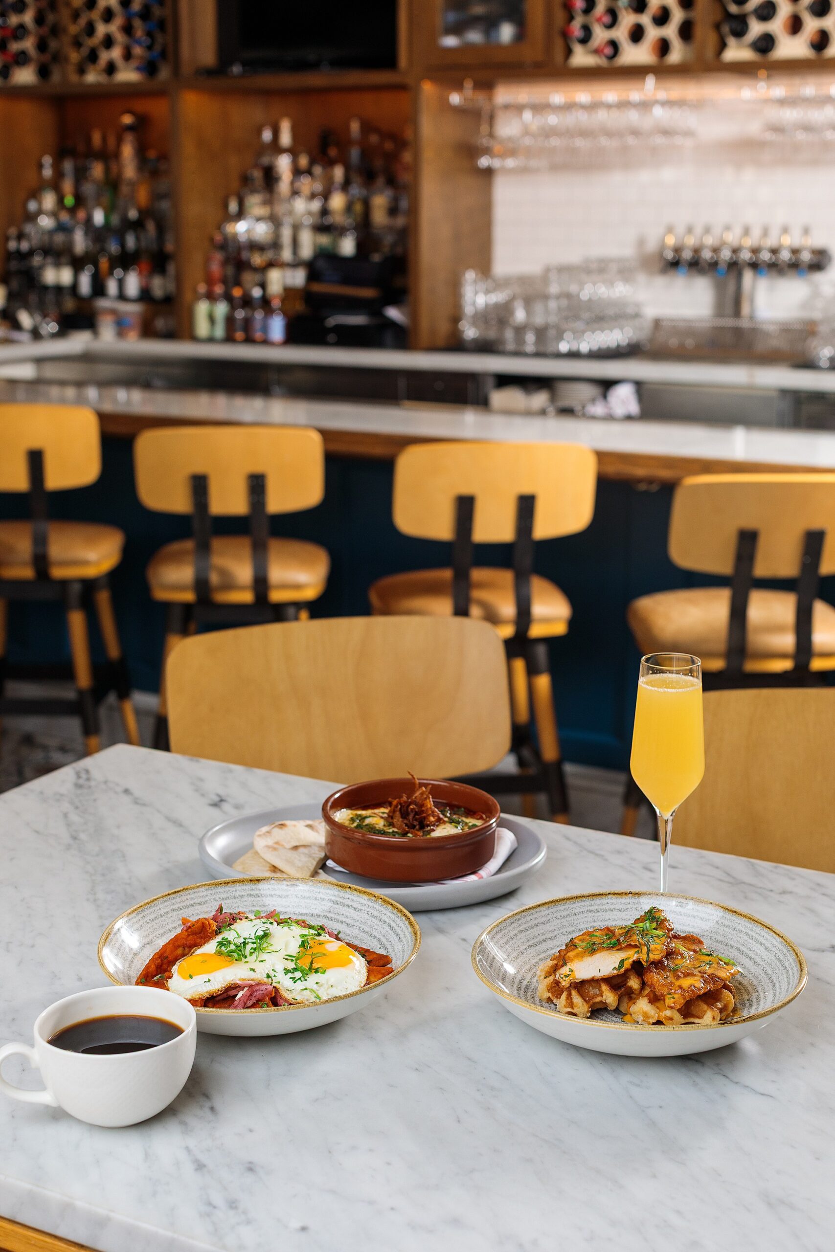 brunch dishes on a marble tabletop at a pretty boutique hotel