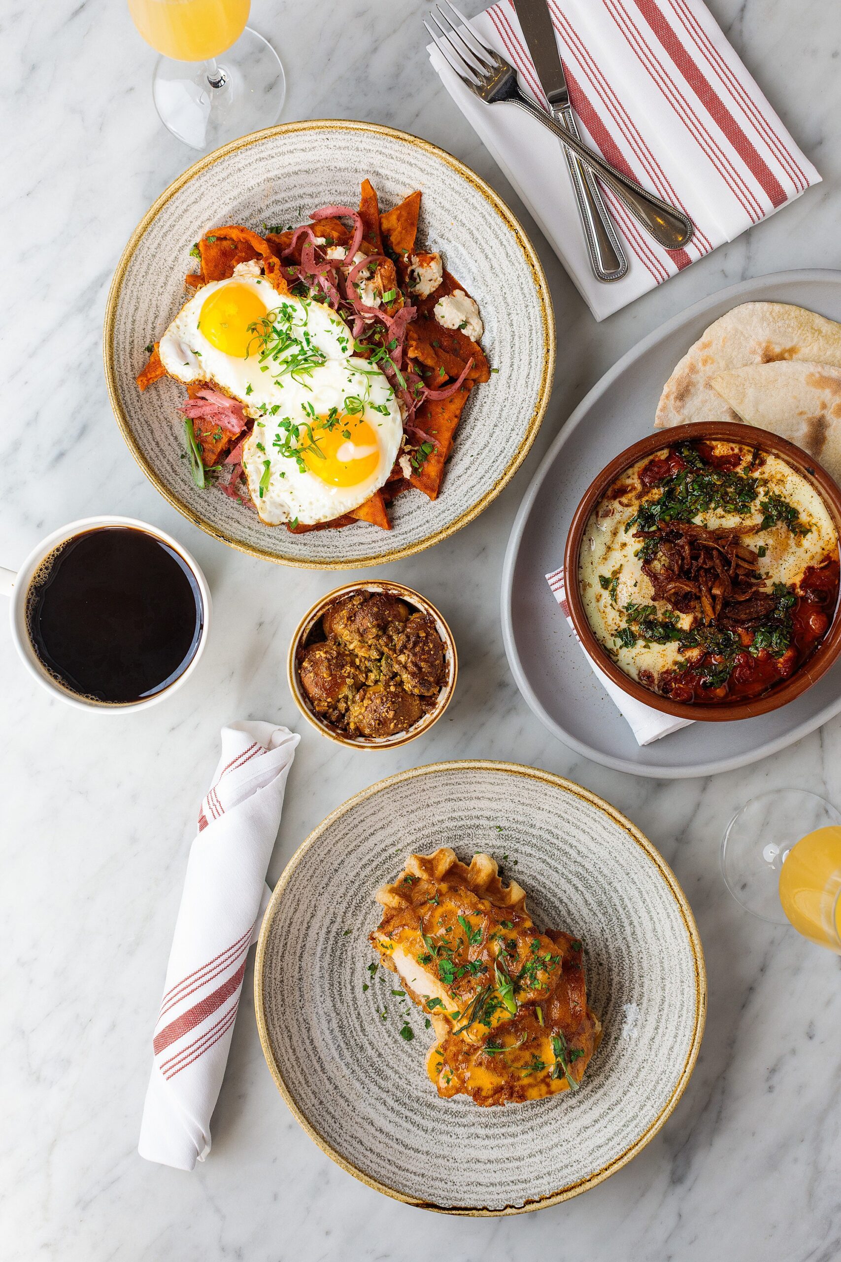 brunch dishes on a marble tabletop at a pretty boutique hotel