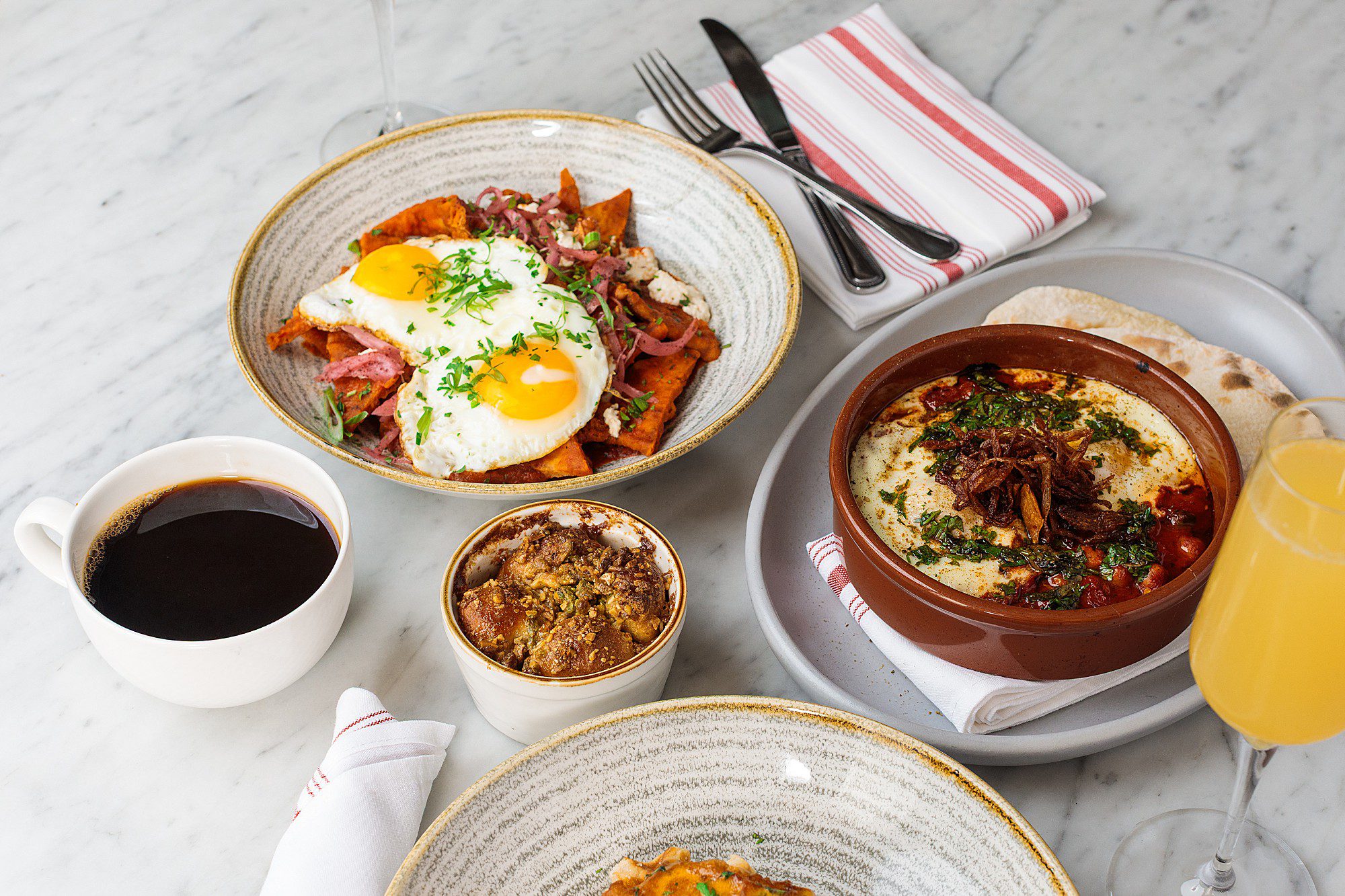 brunch dishes on a marble tabletop at a pretty boutique hotel