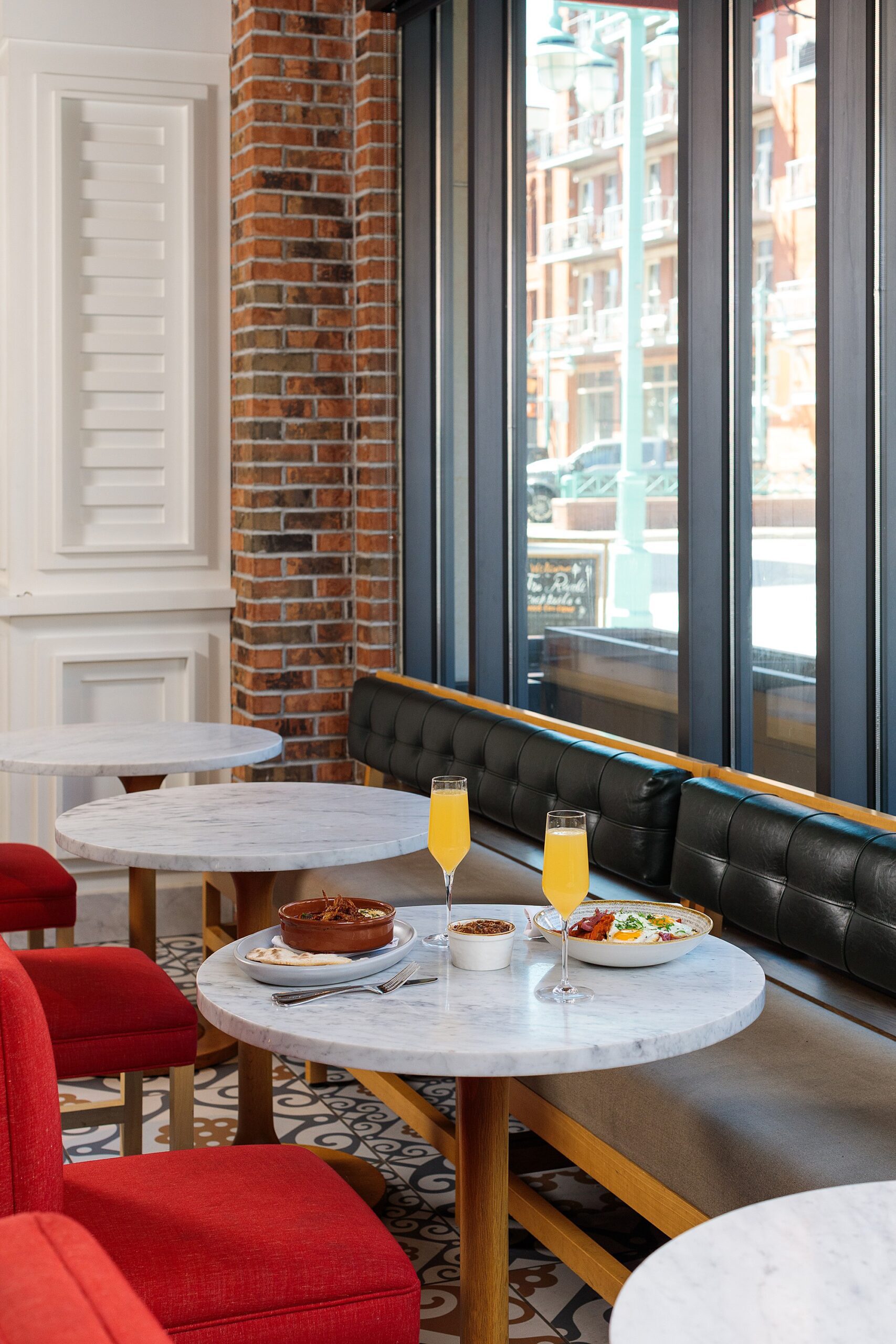 brunch table set up on a round marble tabletop in a pretty boutique hotel