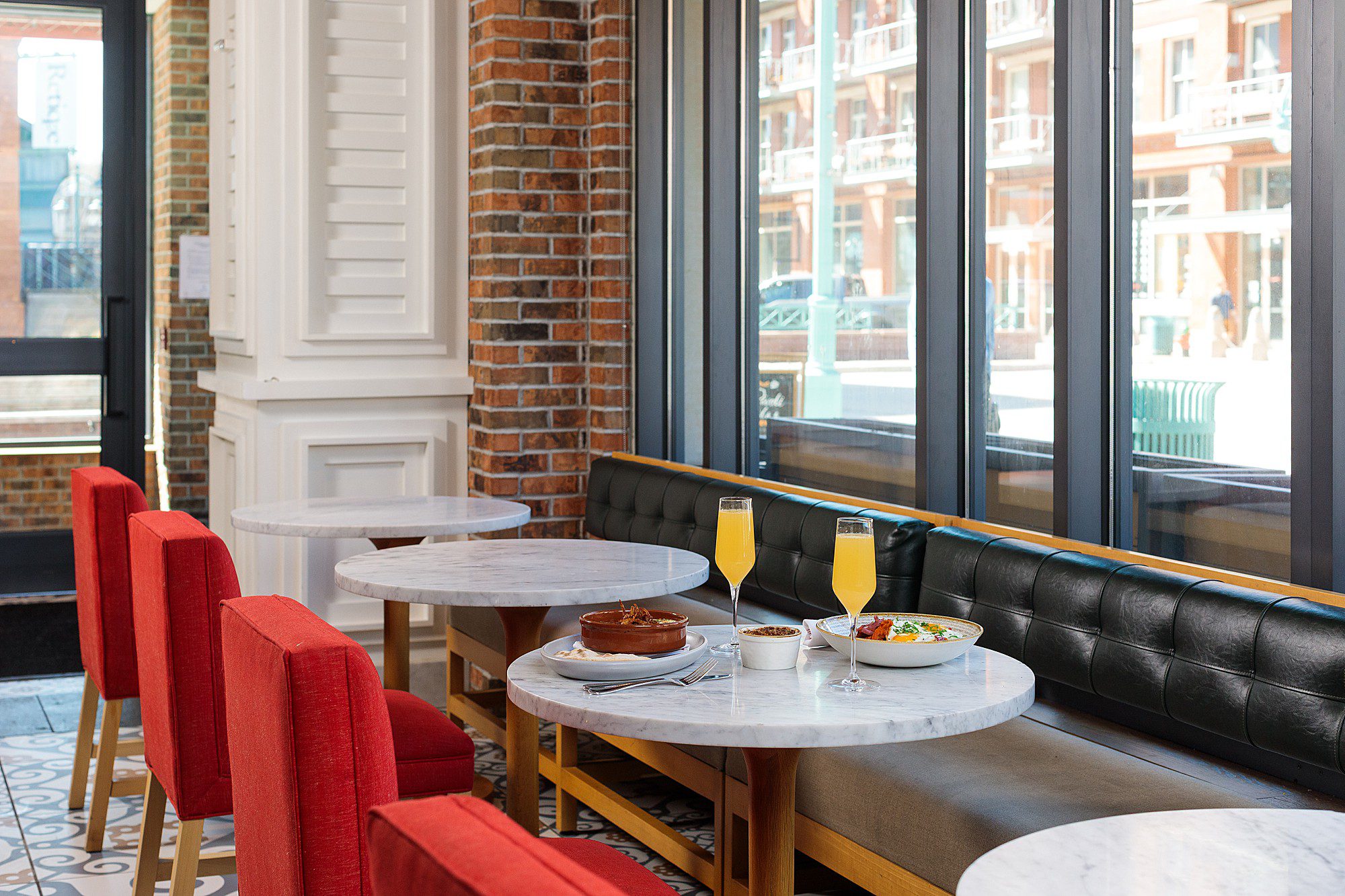 brunch table set up on a round marble tabletop in a pretty boutique hotel