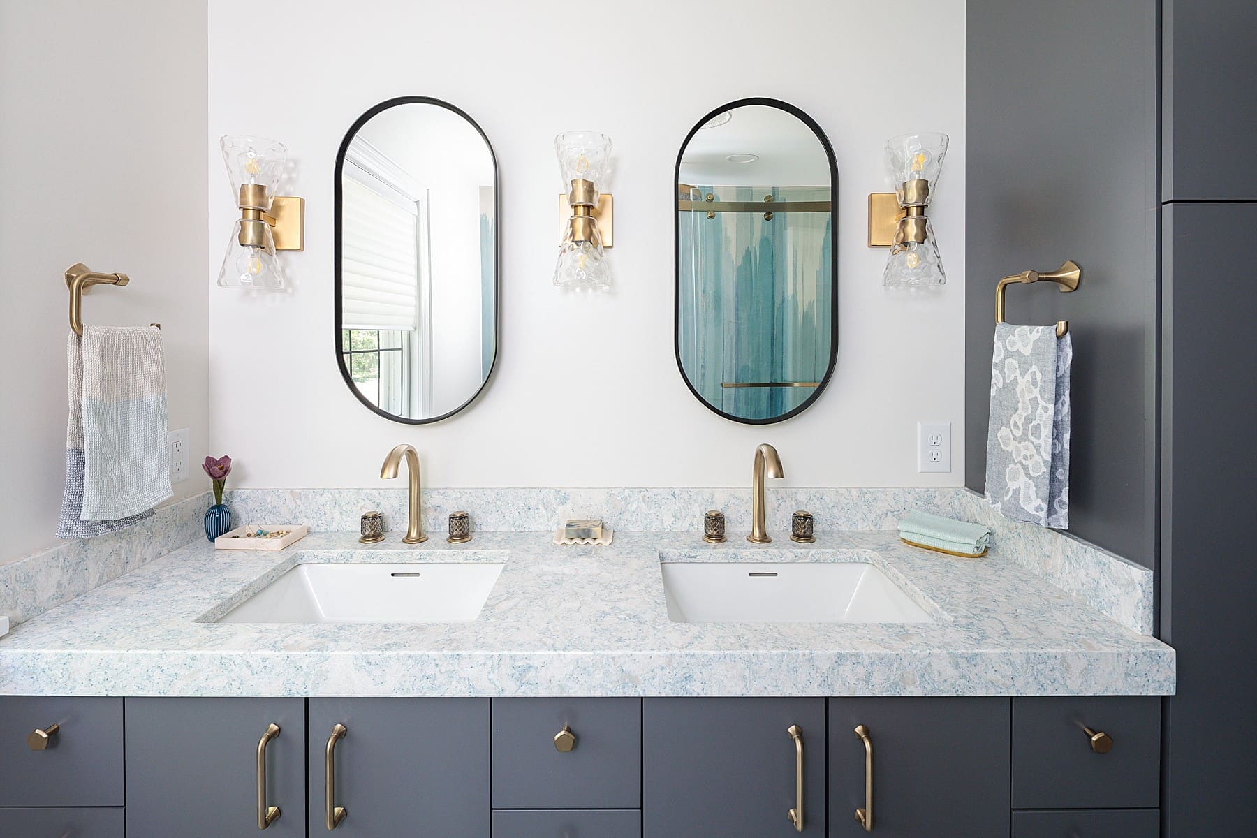 modern bathroom design with gray cabinets and quartz granite countertops and brass finishes and a double sink
