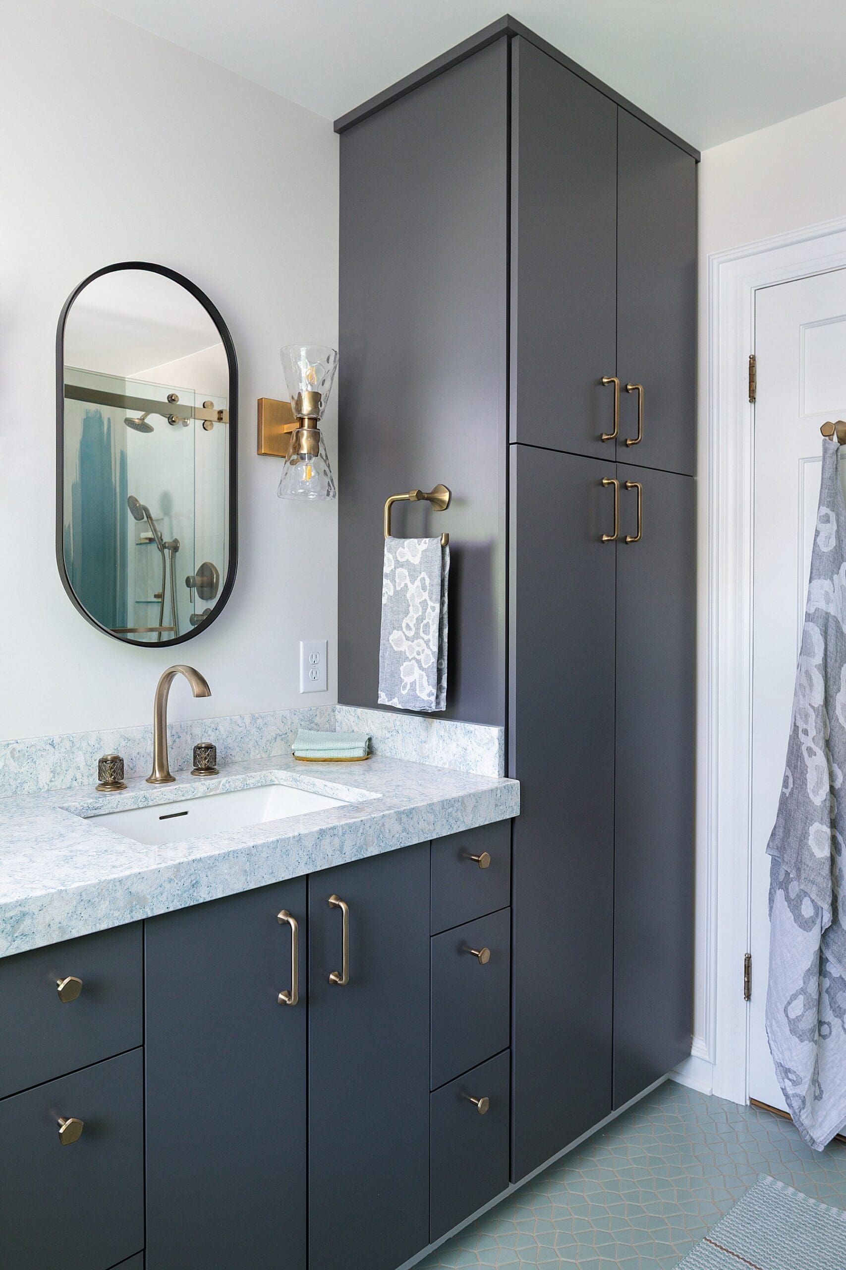 modern bathroom design with gray cabinets and quartz granite countertops and brass finishes and a double sink