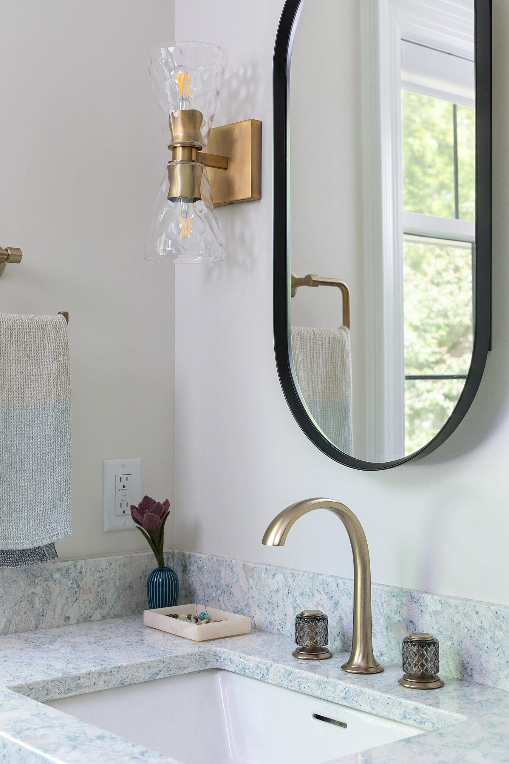 modern bathroom design with gray cabinets and quartz granite countertops and brass finishes and a double sink